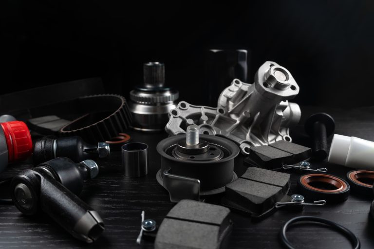 Lot,Of,Auto,Parts,Lie,On,Wooden,Black,Background