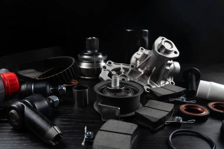 Lot,Of,Auto,Parts,Lie,On,Wooden,Black,Background