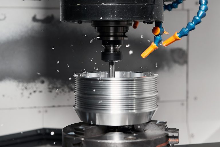Metalworking, a numerically controlled milling machine cuts complex metal parts with high precision