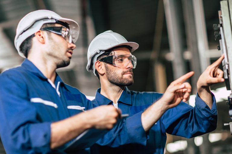 Engineer,Teamwork,Checking,Control,Panel,And,Teaching,New,Worker,To