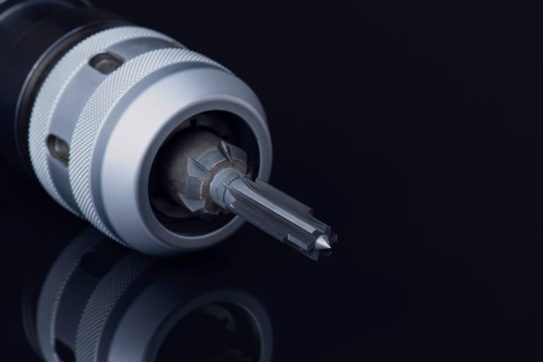 reamer in chuck holder. 6 teeth cutting edge right hand. tools special coating. Material Carbide. Isolated on black background. Drilling metal, cast iron, Aluminum, parts automotive