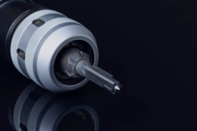 reamer in chuck holder. 6 teeth cutting edge right hand. tools special coating. Material Carbide. Isolated on black background. Drilling metal, cast iron, Aluminum, parts automotive